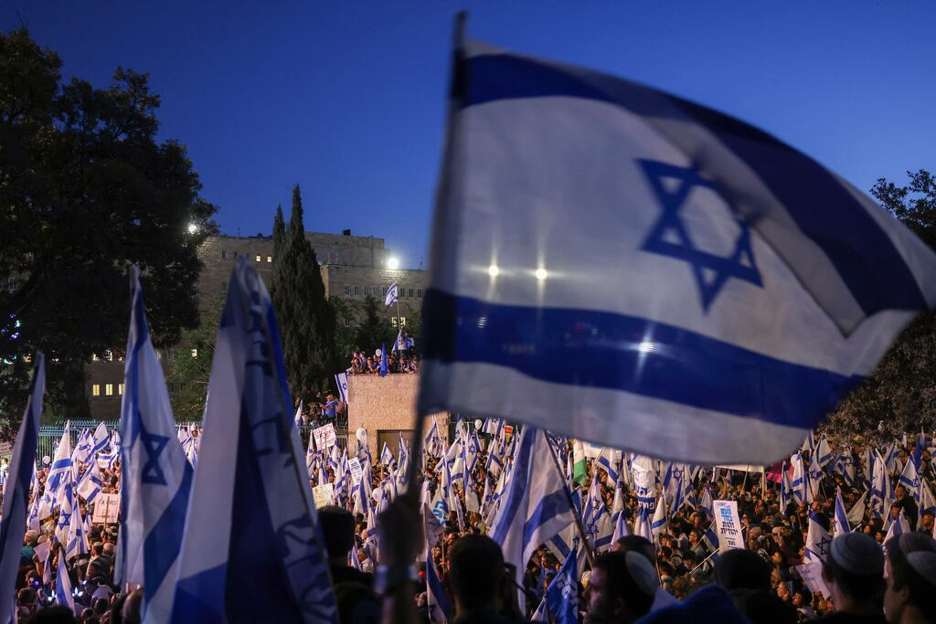 Pro-government protesters wave the Israeli flag as they gather near Israel's parliament in Jerusalem in support of the push to overhaul the justice system. Photograph: Ahmad Gharabai/AFP via Getty Images