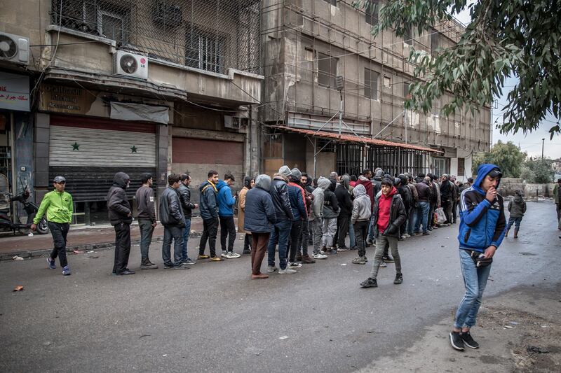 A queue for bread in central Damascus. Photograph: Sally Hayden
