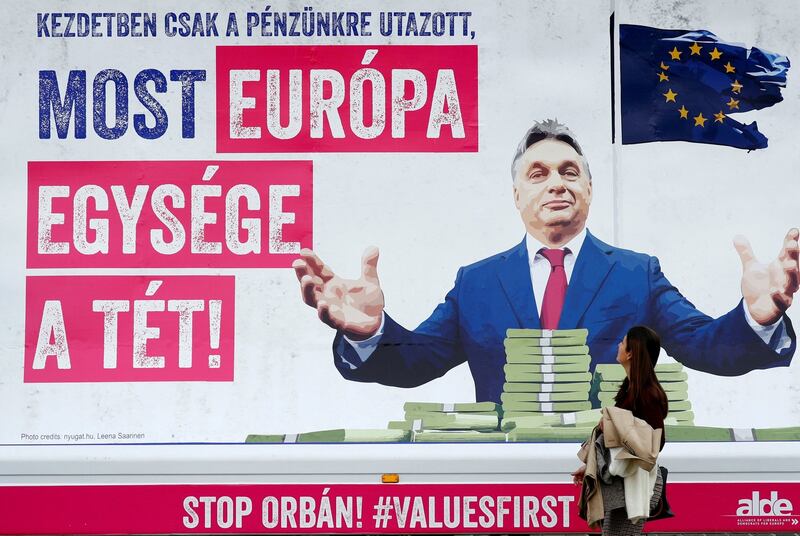 A pedestrian looks at a billboard truck showing a picture of Hungary’s Viktor Orban which reads; ‘First he just wanted to take our money, now the unity of Europe is at stake’, outside the European Parliament in Brussels on November 6th. Photograph: Francois Lenoir/Reuters/File