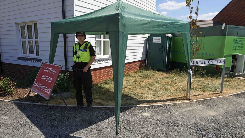 Police officers stand guard at a residential house in Amesbury, southern England. Photograph: Getty Images