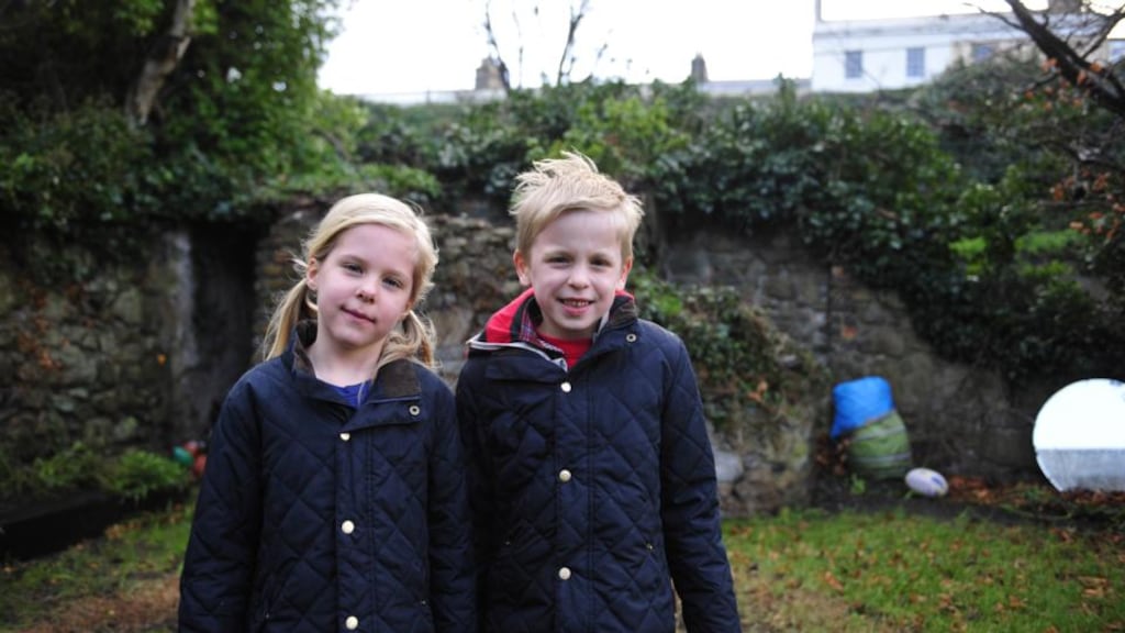 Alice and Piers Postma in their garden in Monkstown, Co Dublin. In the early hours of Friday morning, high winds lifted their trampoline over the garden wall and onto the Dart train line. Photograph: Aidan Crawley.