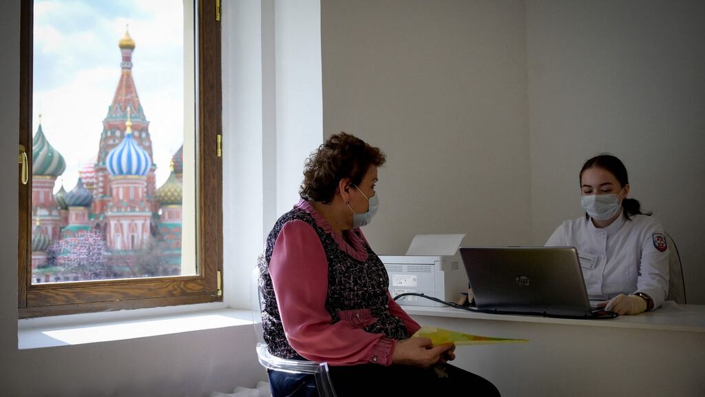 A healthcare worker checks a woman before she gets a dose of Russia’s Sputnik V Covid-19 vaccine in Moscow on April 26th. Photograph: Natalia Kolesnikova/AFP