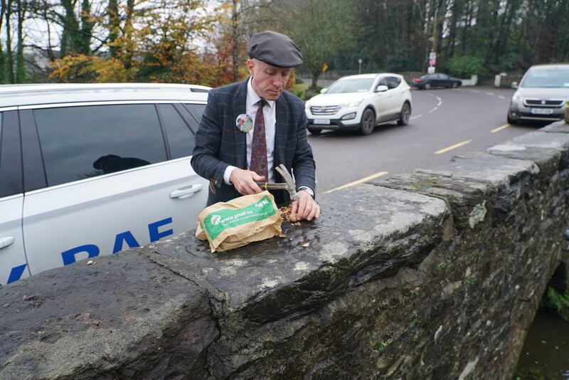 Michael Healy Rae takes a break from the campaign trail to hammer nuts on a bridge in Milltown, Co.Kerry. Photograph: Enda O’Dowd