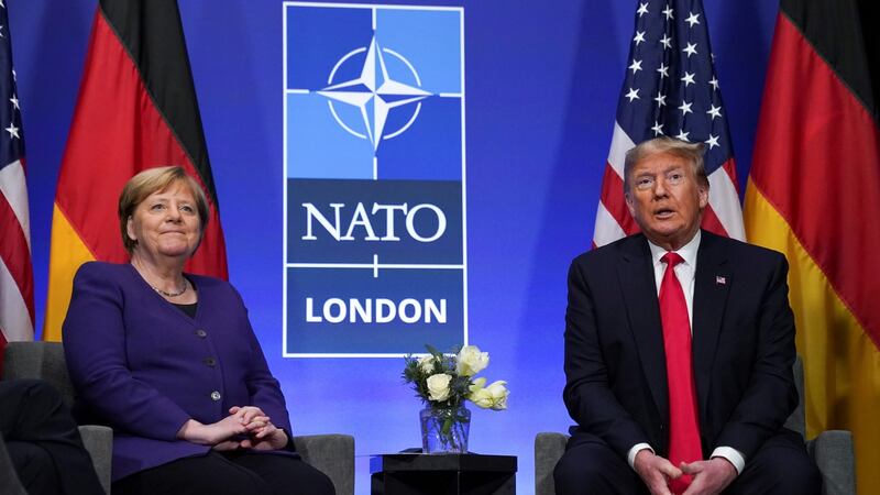 US president Donald Trump and German chancellor Angela Merkel speak to the press at the Nato summit in Watford on Wednesday. Photograph: Kevin Lamarque/Reuters