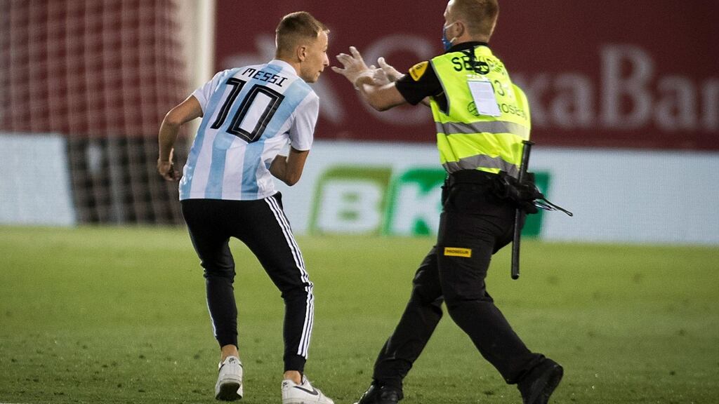 The fan wearing a number 10 Argentina shirt runs onto the pitch during the match between RCD Mallorca and FC Barcelona at the Visit Mallorca stadium in Palma de Mallorca on Saturday. Photograph: Jaime Reina/AFP via Getty Images