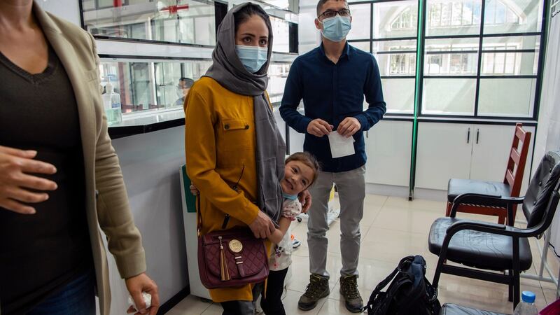 Afghan air force Maj Naiem Asadi, his wife, Rahima, and their daughter, Zainab, arrive for coronavirus testing at a clinic in Kabul on May 31st, the day before their departure from Afghanistan. Photograph: Kiana Hayeri/The New York Times