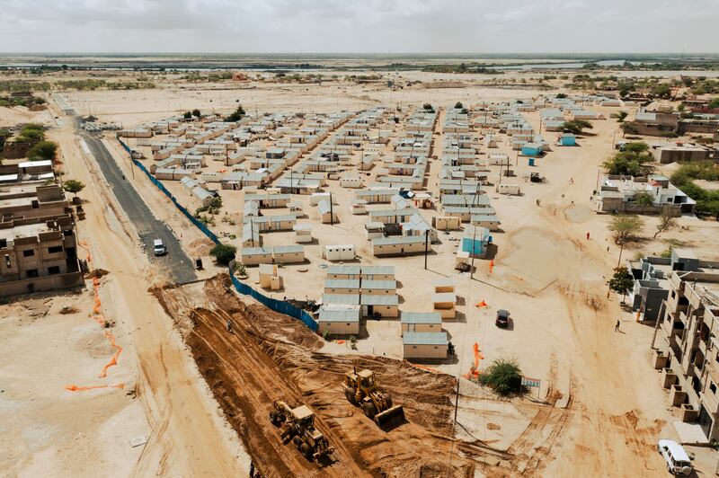 An aerial view of Boudiouk, a camp for climate refugees. The camp consists of rows of identical ready-made cabins, but if all goes as planned it will eventually offer displaced residents newly constructed houses, schools, a health care centre and a market. Photograph: Sirio Magnabosco