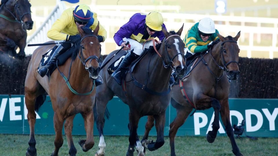Tony McCoy riding Carlingford Lough (right) clears the last to win The Hennessey Gold Cup at Leopardstown. Photograph: Alan Crowhurst/Getty Images