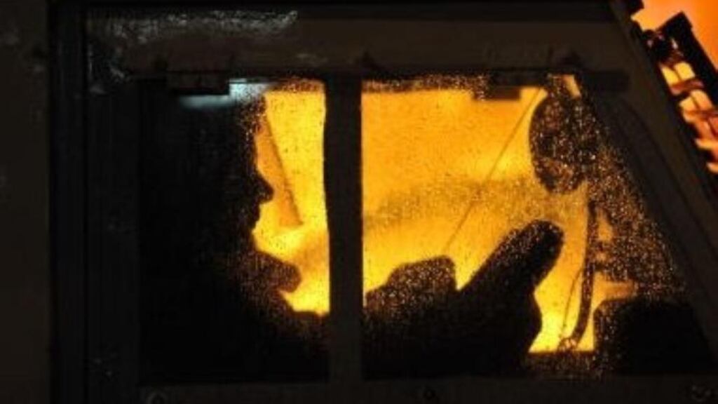 A file image of a PSNI officer inside a police vehicle as petrol bombs are thrown in Belfast. Photograph: Getty