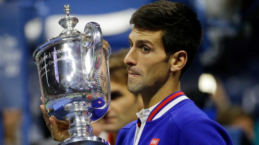 Novak Djokovic, of Serbia, holds up the championship trophy after defeating Roger Federer, of Switzerland, in the men’s championship match of the US Open. Photograph: David Goldman/AP