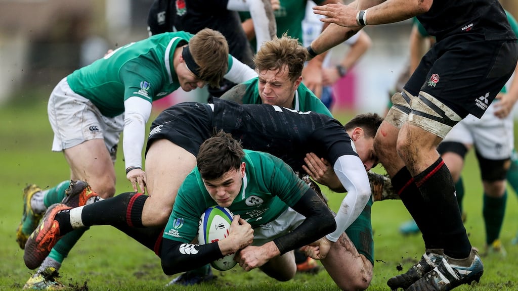 Ireland’s David Ryan is tackled during the World Junior Championship match against England. Photo: Pablo Gasparini/Inpho