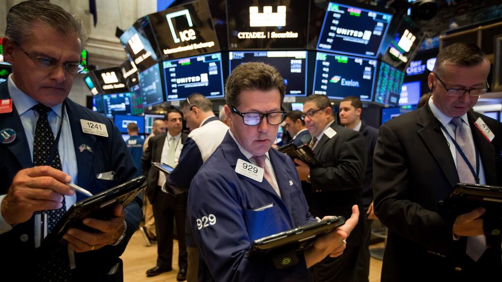 Traders work on the floor of the New York Stock Exchange (NYSE). US stocks reached the highest since mid-March, tracking peers in Europe and Asia. Photograph: Michael Nagle/Bloomberg