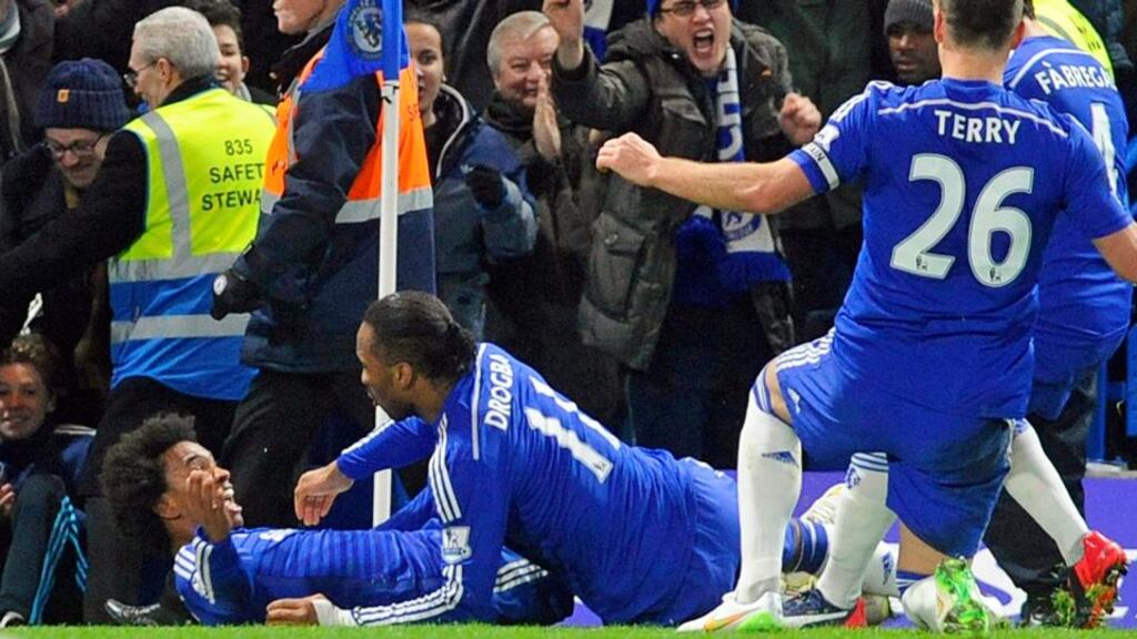 Chelsea’s Willian (left) celebrates with teammates after scoring the winner against Everton at Stamford Bridge. Photograph: Gerry Penny / EPA
