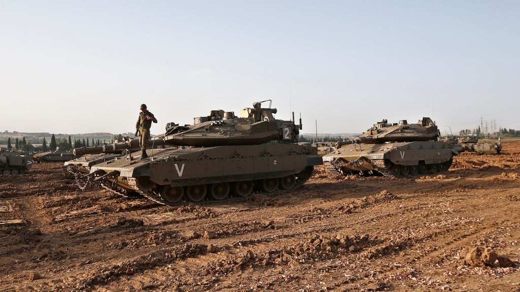 An Israeli soldier stands atop of a tank near the border with Gaza, in southern Israel. Photograph: Ronan Zvulun/Reuters