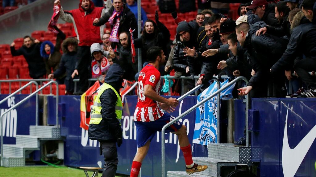 Atletico Madrid’s Diego Costa celebrates scoring their second goal with fans before being sent off during the La Liga clash with Getafe. Photo: Javier Barbancho/Reuters