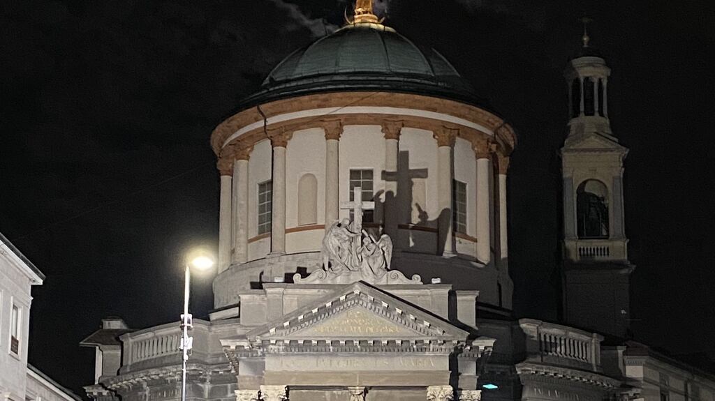 The sub-alpine calm of Viale Papa Giovanni XXIII bathed in a waning moon that almost aligned with the halo of stars on a Virgin Mary overlooking us from the top of a church dome