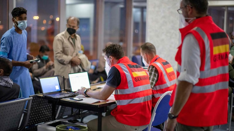 A handout photo provided by the German armed forces Bundeswehr shows the registration of evacuees from Kabul, Afghanistan, following a rapid Covid-19 test, at the airport in Tashkent, Uzbekistan, during a military evacuation operation. Photograph: AFP via Getty Images