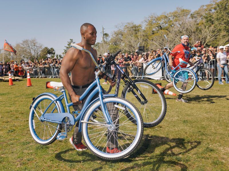 Competitors in an event called 'A Catalytic Converter, 2 Bikes, and a Handful of Copper Pipes' at the Florida Man Games. Photograph: Jason Andrew/The New York Times