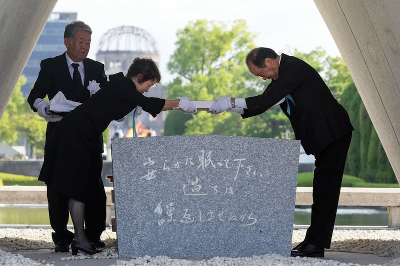 Hiroshima mayor Kazumi Matsui (R) places a list of atomic bomb victims in the cenotaph during the Peace Memorial Ceremony for the 80th anniversary of the atomic bombing of Hiroshima at Peace Memorial Park in Hiroshima, Japan. Photograph: EPA
