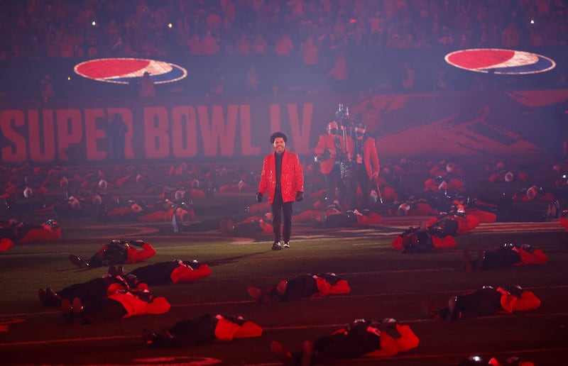 The Weeknd on the pitch surrounded by similarly dressed dancers during the show. Photograph: CJ Gunther/EPA
