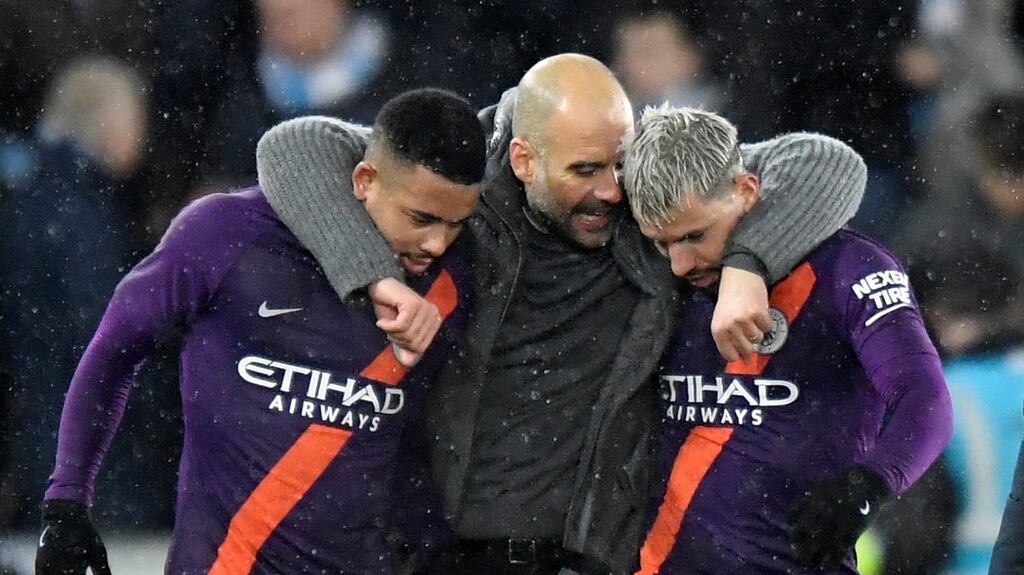 Manchester City’s Sergio Aguero and Gabriel Jesus celebrate with manager Pep Guardiola after the match against Swansea. Photograph: Reuters/Toby Melville