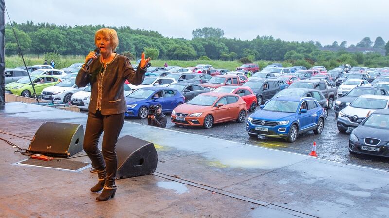 Philomena Begley performing for drive-in revellers, who have packed a football ground for Northern Ireland’s first drive-in country music concert at Ballymena Showgrounds in Co Antrim. Photograph: Paul Faith/PA Wire