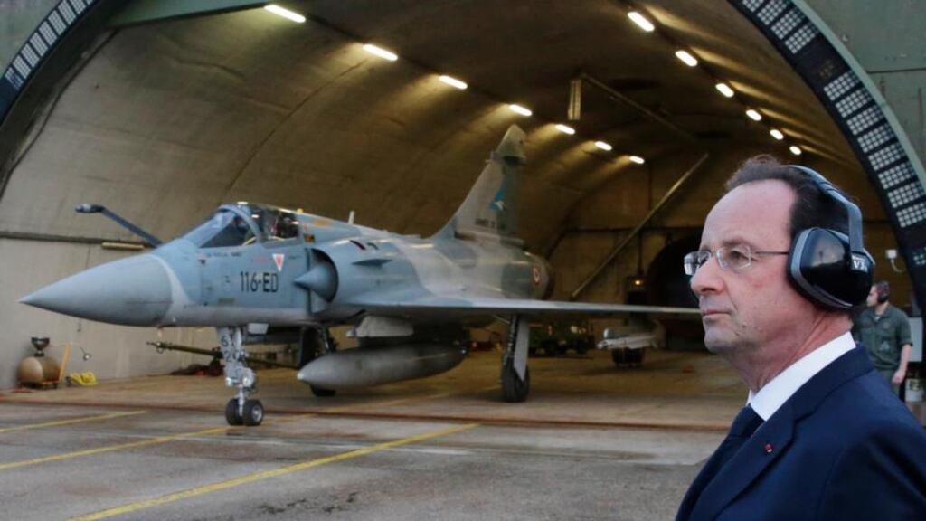 French president Francois Hollande watches a Mirage 2000-5 who taxis out of his hangar during a visit to the Creil military airbase. Photograph: Philippe Wojazer/Reuters
