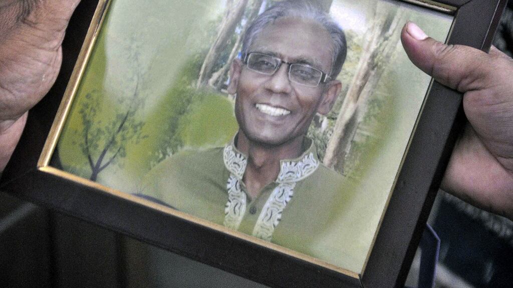 A man holds a portrait of Bangladeshi professor Rezaul Karim Siddique, who was hacked to death by unidentified attackers in Rajshahi. Photograph: MD Abdullah Iqbalmd/AFP/Getty Images