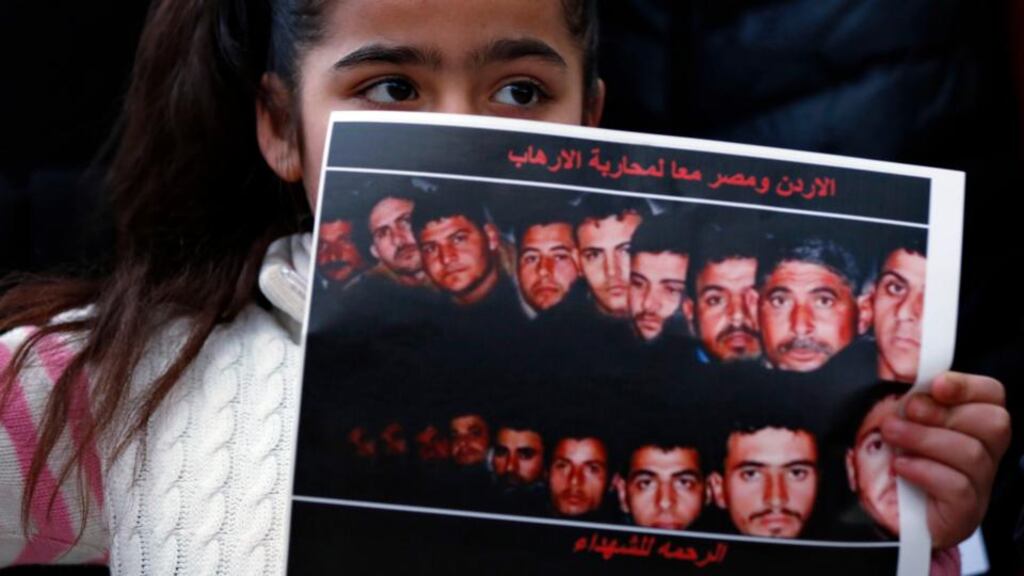 A girl holds up a poster with pictures of the 21 Egyptian Coptic Christians beheaded by Islamic State in Libya. A series of fatal bombings in Libya on Friday have been linked to the decision to launch airstrikes in response to the beheadings. Photograph: Muhammad Hamed/Reuters.