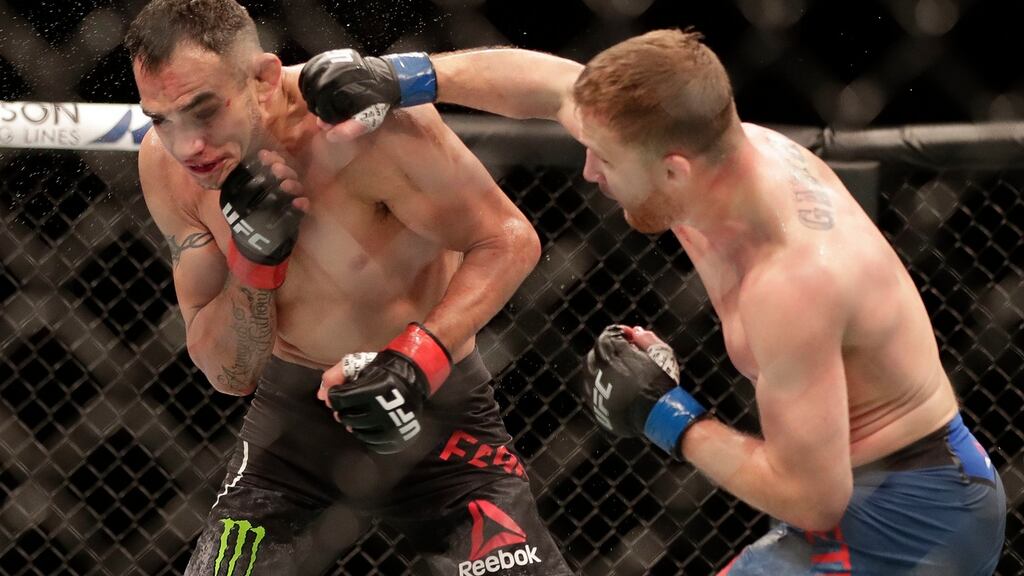 Justin Gaethje, right, punches Tony Ferguson during their UFC 249 bout which Gaethje won to take the interim lightweight title. Photo: John Raoux/AP Photo