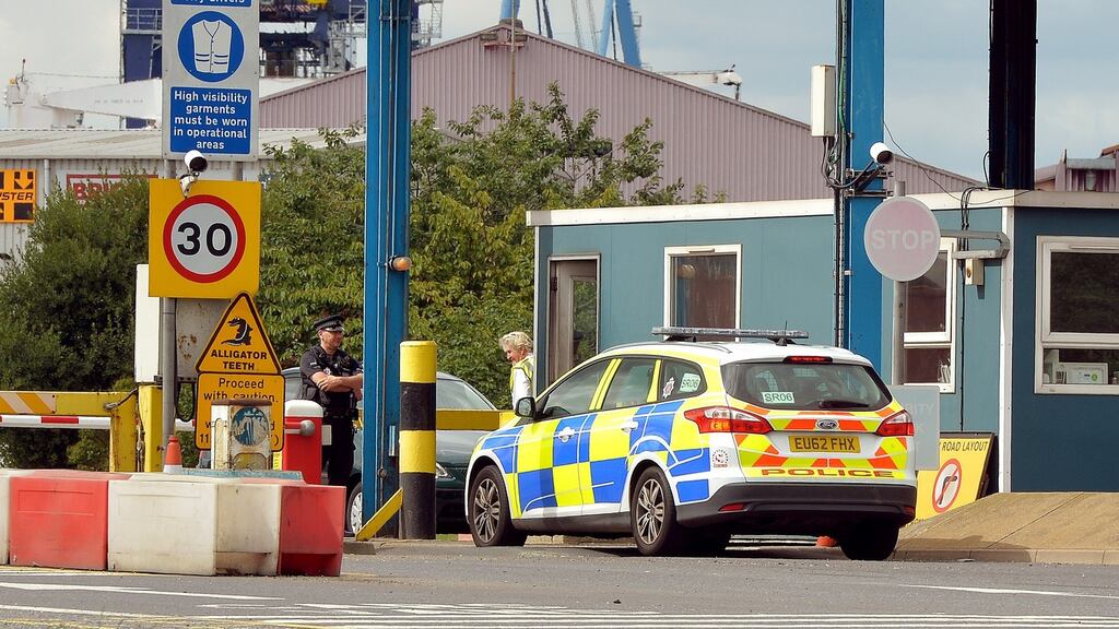 A police car arrives at the main entrance to Tilbury Docks in Essex, where a shipping container was found with illegal immigrants inside with one dead and the rest ill and taken to hospital. Photograph: John Stillwell/PA Wire