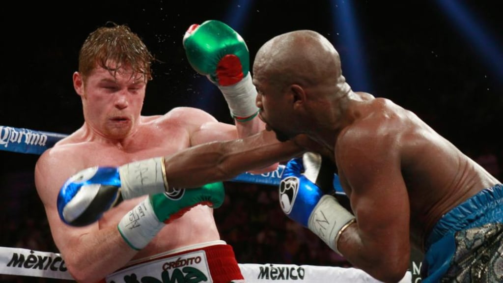 Mexico’s Saúl Álvarez takes a punch from Floyd Mayweather Jr of the US during their WBC/WBA title fight at the MGM Grand Garden Arena in Las Vegas. Photograph: Steve Marcus/Reuters