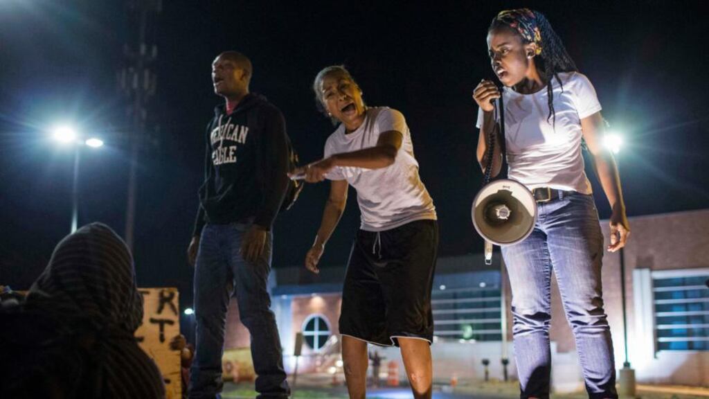 Protesters gather near the police department in Ferguson, Missouri, last night, following clashes    between police and demonstrators on Thursday. Photograph: Reuters