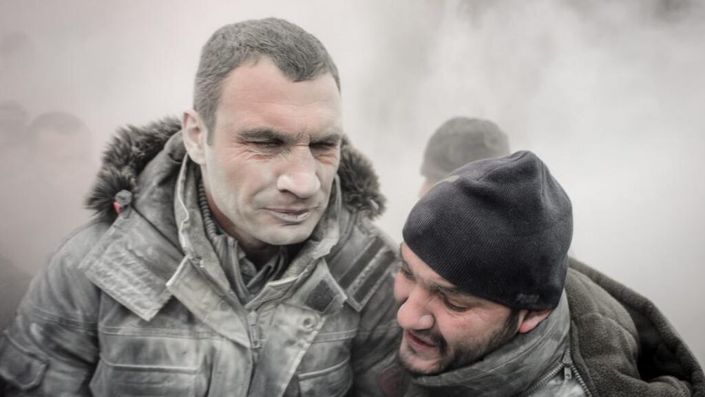 Ukrainian opposition leader Vitali Klitschko (left) after he was sprayed with a dry chemical fire extinguishant by radical protesters while trying to stop clashes between protestors and riot police during a protest in the Ukrainian capital Kiev yesterday. Photograph: EPA/Roman Pilipey
