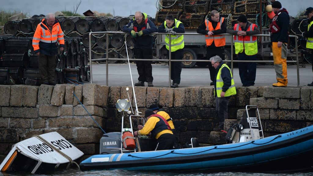 Debris from the helicopter being taken to the pier in Blacksod, scene of the search for missing Coast Guard helicopter crew at Blacksod, Co Mayo. Photograph: Dara Mac Dónaill