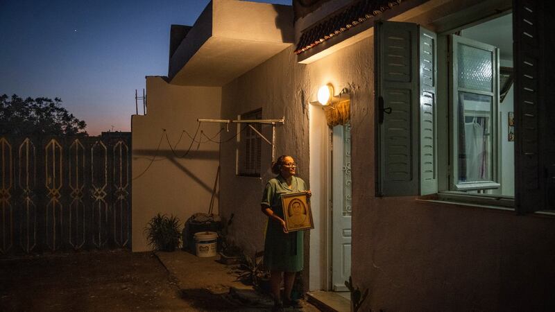 Arbia Jneihi at her home in Tunis with a portrait of her husband, who was killed in Tunisia’s 2011 revolution. Photograph: Ivor Prickett/New York Times