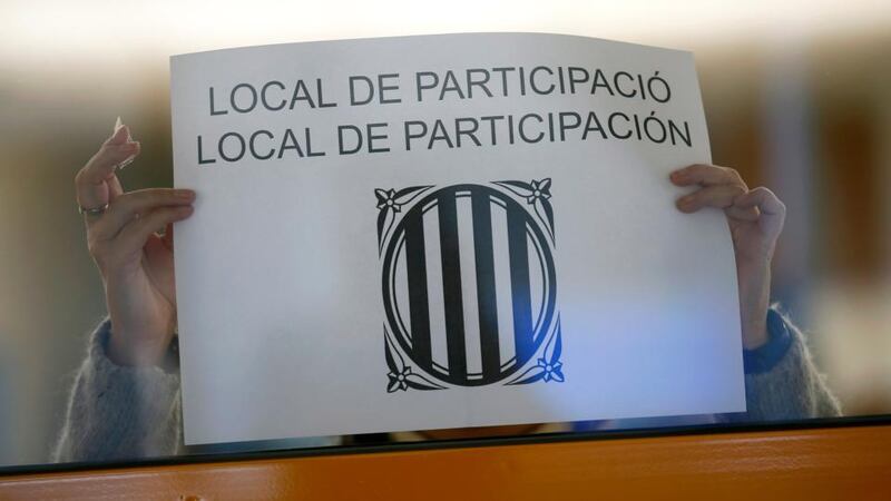 A volunteer makes preparations at a polling station in Sant Feliu de Llobregat, near Barcelona. Photograph: Albert Gea/Reuters