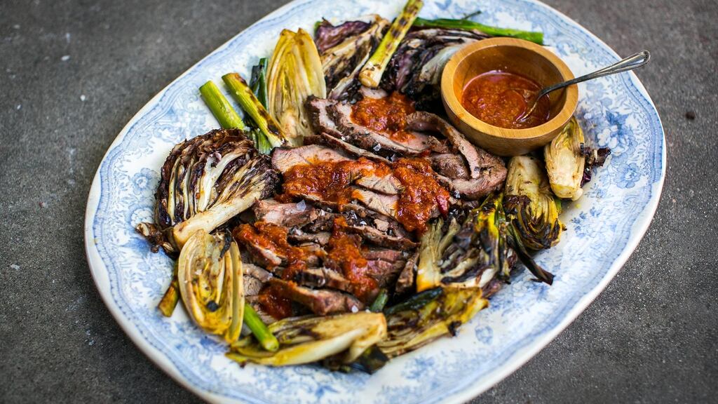 Slice the lamb thinly and serve with charred vegetables and a generous drizzle of the orange harissa paste and the resting juices