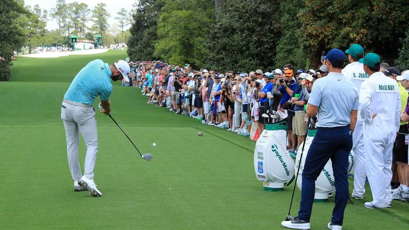 Dustin Johnson hits a tee shot on the 18th during his practice round with McIlroy. Photo: David Cannon/Getty Images
