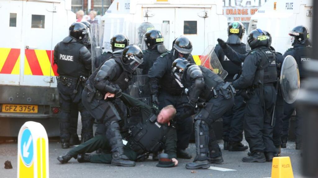 A police officer is dragged away after being struck by an object thrown by Loyalist protesters at the Ardoyne Roundabout, Belfast in July. Photograph: Brian Lawless/PA Wire