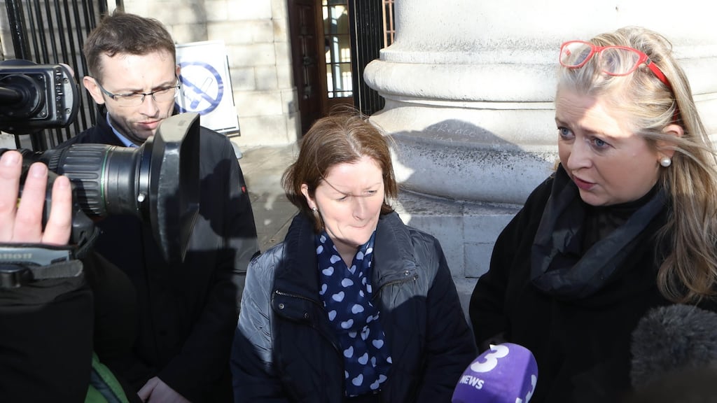 Ray and Aoife Manton, of Dualla Road, Cashel, Co Tipperary, look on as solicitor Anne M Fitzpatrick talks to the media outside the Four Courts on Thursday. Photograph: Collins Courts