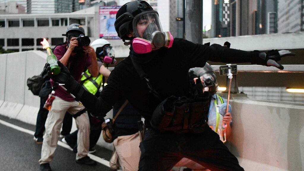 A protester throws a molotov cocktail at police in the Admiralty area of Hong Kong on Saturday. Photograph: Getty