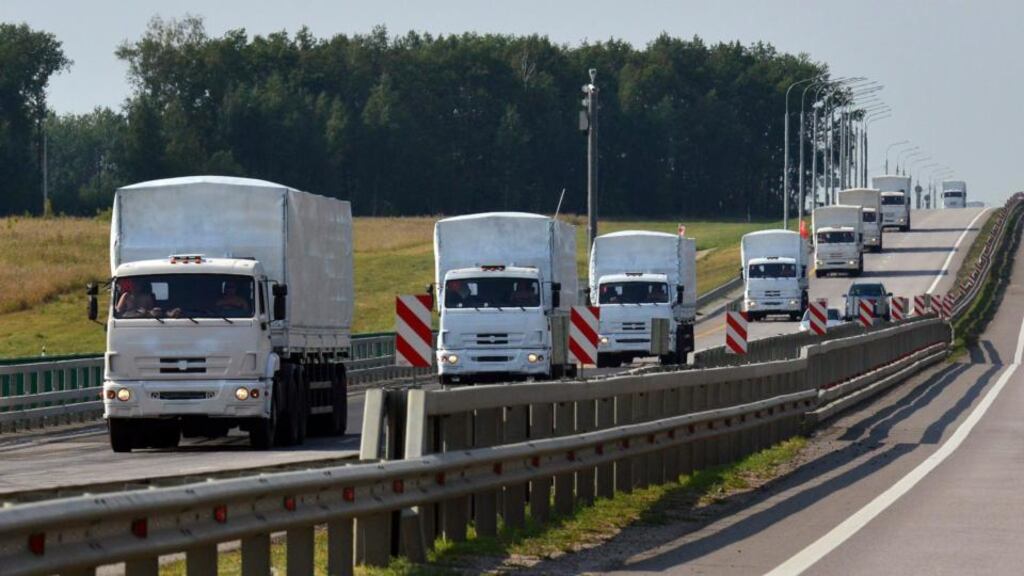 A Russian convoy of trucks carrying humanitarian aid for Ukraine drives along a road near the city of Yelets . Photograph: Nikita Paukov /Reuters