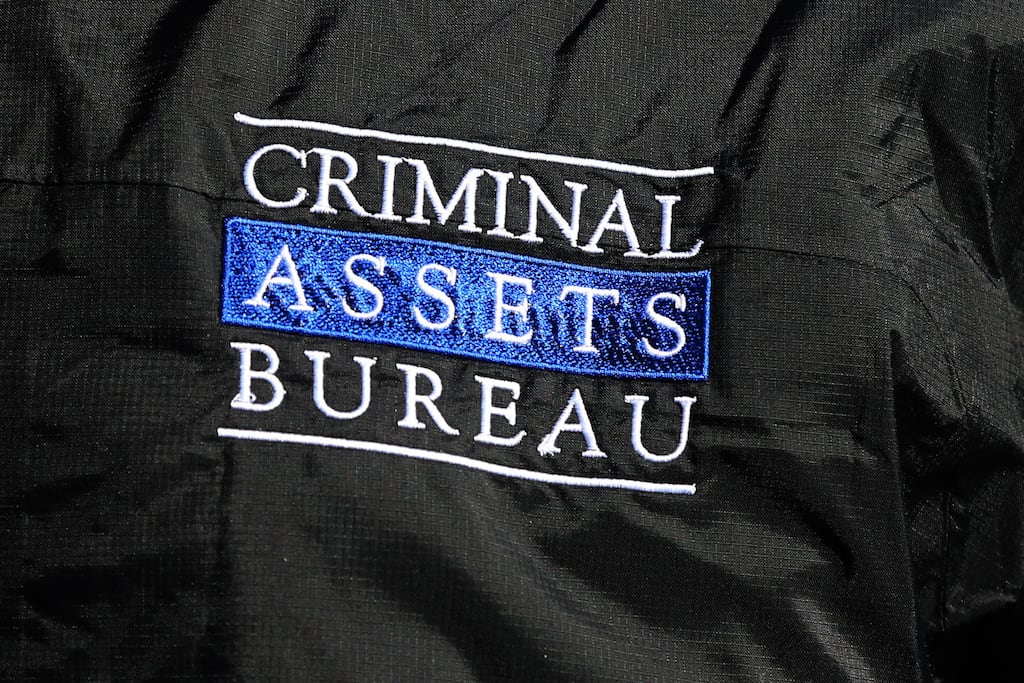 The logo on a jacket of a member of the Criminal Assets Bureau  carrying out searches on homes and businesses in Dublin targeting the activities of a south inner city-based crime group linked to David Byrne, who was murdered in the Regency Hotel.  PRESS ASSOCIATION Photo. Picture date: Wednesday March 9, 2016. See PA story POLICE Raids Ireland. Photo credit should read: Niall Carson /PA Wire