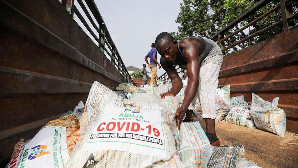 Men load food aid in a truck in Abuja, Nigeria. African and Latin American countries participated in the transition to a more multi-polar world but have not escaped peripherality. Photograph: Afolabi Sotunde/Reuters
