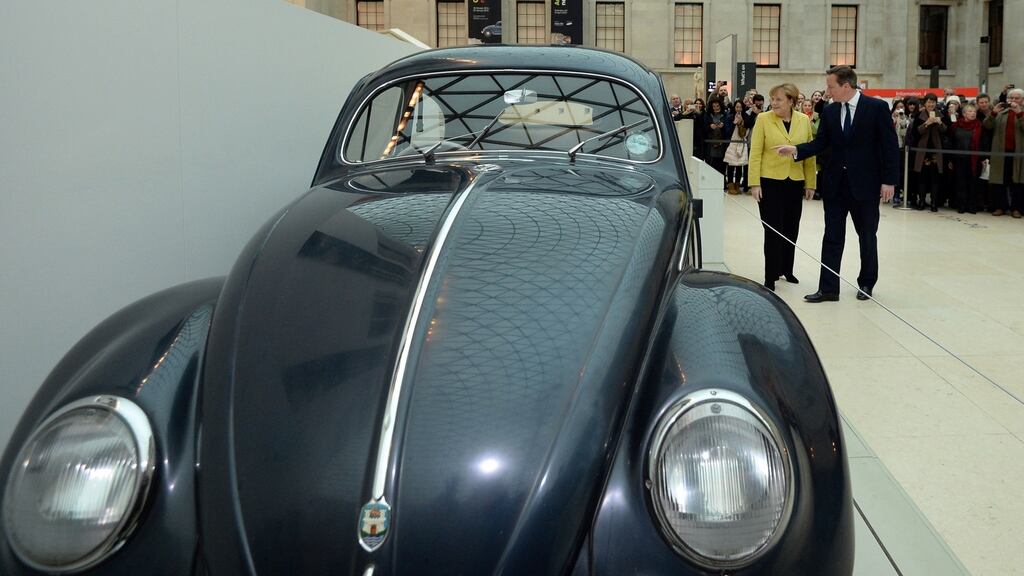 German chancellor Angela Merkel and former British prime minister David Cameron looking at a Volkswagen Beetle Type 1 at the British Museum, London. Photograph: Facundo Arrizabalaga/PA