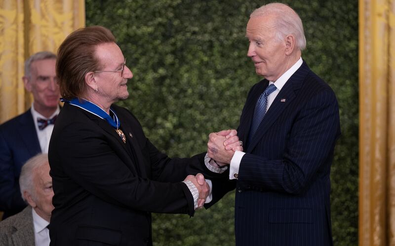 Former US president Joe Biden shakes hands with Bono after presenting the Medal of Freedom during a ceremony at the White House in January. Photograph: Leigh Vogel/UPI/Bloomberg