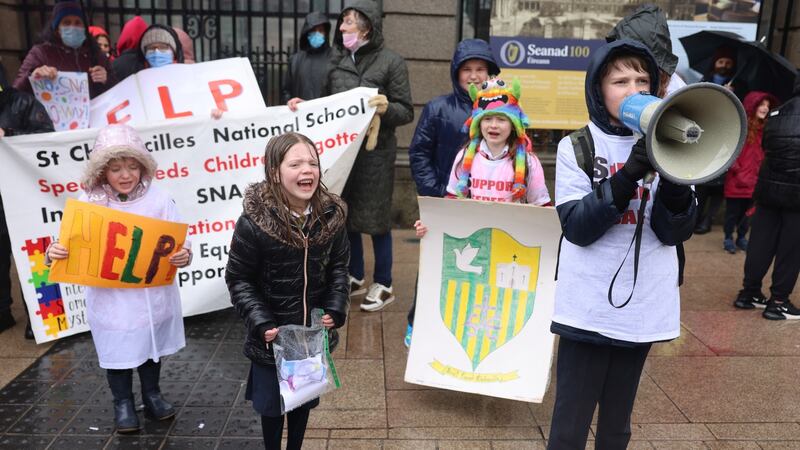 From left: Eimear and Grace Coll, with Molly May and Eli Ball, as parents, pupils and staff at St Colmcille’s National School, Co Louth, protesting outside Leinster House.