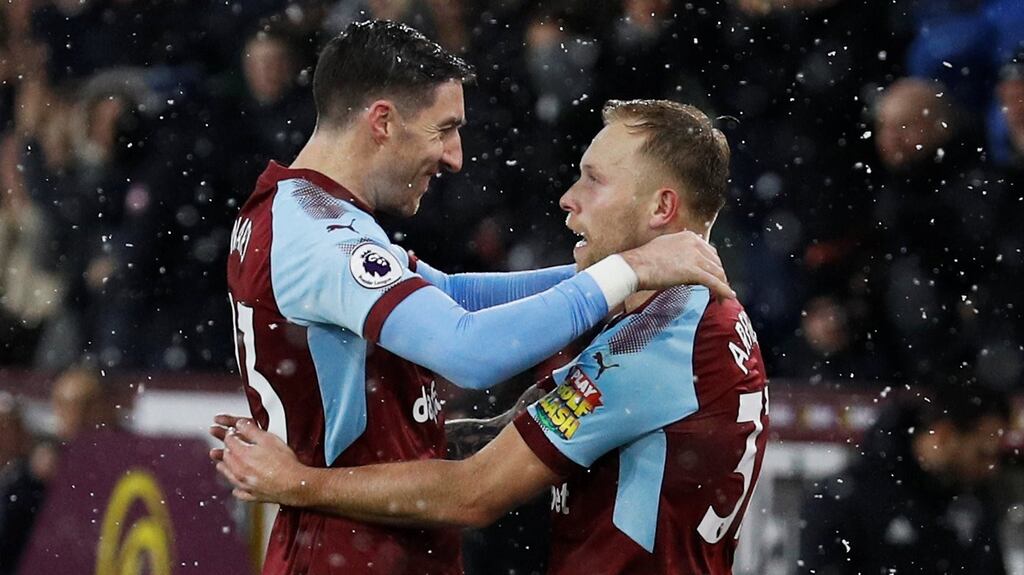 Stephen Ward celebrates with Burnley goalscorer Scott Arfield. Photograph: Phil Noble/Reuters