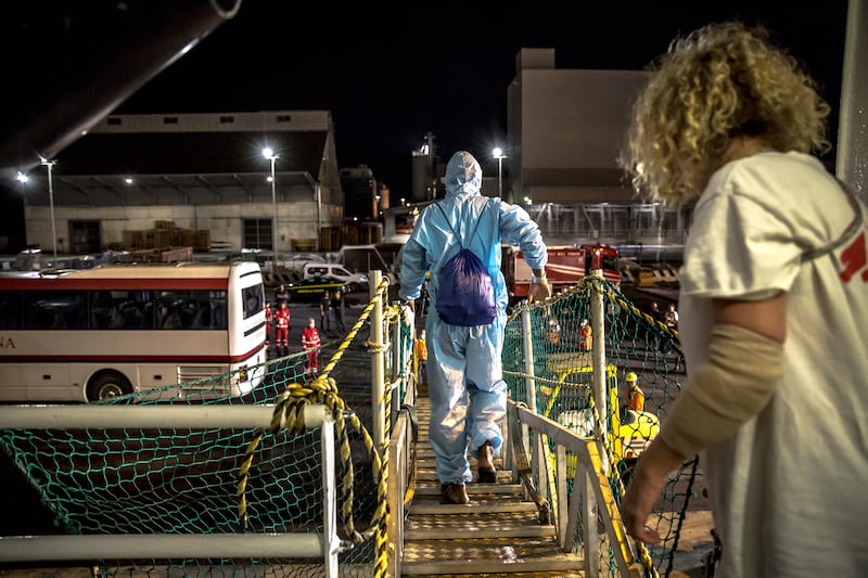 Some of the rescued people disembark the vessel in Ravenna, Italy. Photograph: Sally Hayden